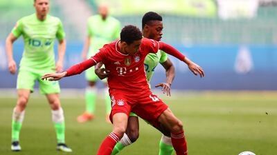 Bayern's Jamal Musiala under pressure from Ridle Baku of Wolfsburg. Getty
