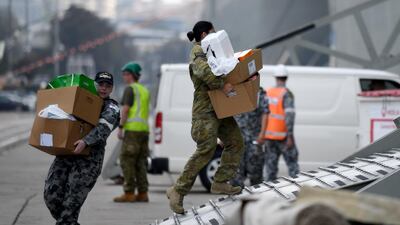 Army and Navy personal load supplies onto HMAS Adelaide as it prepares to leave Garden Island naval base to assist with the ongoing bushfire crisis, in Sydney, New South Wales. EPA