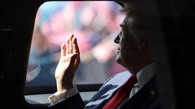 US President Donald Trump waves from his official vehicle as he heads to attend the 47th Asean summit in Kuala Lumpur, Malaysia. Reuters