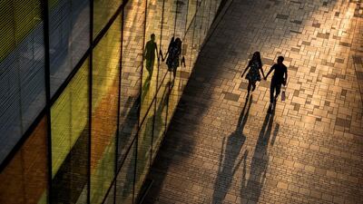 A Chinese couple walk together while shopping at an outdoor mall in the evening on September 5, 2014 in Beijing, China. Kevin Frayer / Getty Images