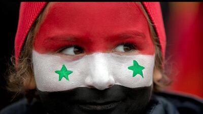 A young girl with her face painted in the colors of the Syrian flag, attends a demonstration in a protest against foreign support for the rebel groups in Syria. Vadim Ghirda / AP Photo
