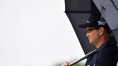US golfer Zach Johnson shelters from the rain under an umbrella during his second round on day two of the 2016 British Open Golf Championship at Royal Troon in Scotland on July 15, 2016. The second round got underway on Friday morning, with expectations for far more trying conditions at Royal Troon. AFP / Ben STANSALL