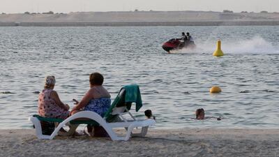 Jetskiers near Al Muneera beach in Abu Dhabi. Pawan Singh / The National