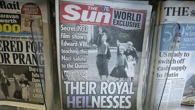 A row of newspapers on display in a London shop includes a copy of The Sun, which shows a picture of Britain's Queen Elizabeth as a child, giving a Nazi salute. Tim Ireland/AP Photo