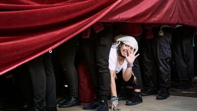 Several 'costaleros' - participants carrying floats with religious sculptures - take a break during the 'Estrella de la Semana Santa de Avila' Holy Tuesday procession in northern Spain. EPA