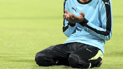 Players pray before the Sharjah Ramadan Cup game between MGM Cricket Club and Pacific Group