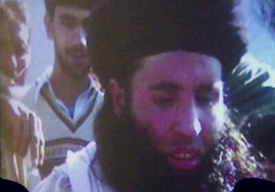 In this file image made from video broadcast on Thursday, Nov. 7, 2013, undated footage of Mullah Fazlullah is shown on a projector in Pakistan. (AP Photo via AP Video, File)