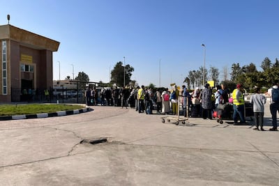People passing through Egypt's Rafah border crossing with the Gaza Strip, on Thursday, amid the ongoing battles between Israel and the Palestinian group Hamas. (Photo by AFP)