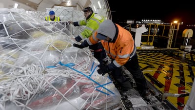 Tack and other equine equipment is loaded into the hold.