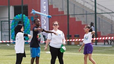 Children participating in throwing games at the Infinity Games. Leslie Pableo / The National