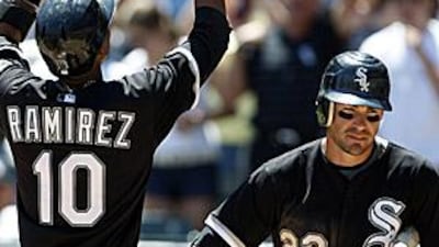 The White Sox's Alexei Ramirez, left, celebrates with Scott Podsednik after hitting a two-run home run against the Cubs.