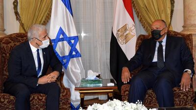 Egyptian Foreign Minister Sameh Shoukry, right, meets Israeli Foreign Minister Yair Lapid in Cairo. Mr Lapid is visiting to discuss with Egyptian officials the ceasefire with Gaza militants and the Israeli economic recovery plan for Gaza, among other topics. EPA