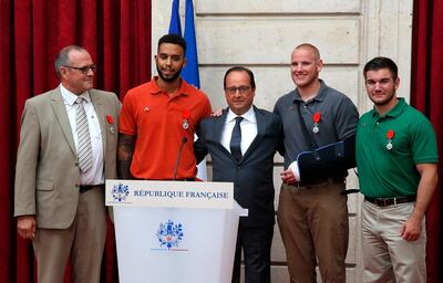 French president Francois Hollande commends the bravery of train passengers, from left. Chris Norman, Anthony Sadler, Spencer Stone, and Alek Skarlatos. AFP