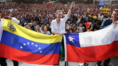 Venezuelan opposition leader Maria Corina Machado holds the flags of Venezuela and Chile during a rally in Santiago, Chile. EPA