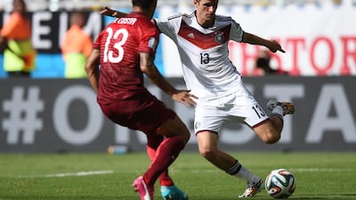 Thomas Muller challenges Ricardo Costa of Portugal during Germany's World Cup Group G opening win on Monday. Francisco Leong / AFP / June 16, 2014