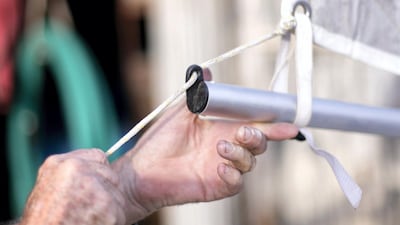Grant McCreadie adjusts a sail rope. Reem Mohammed / The National