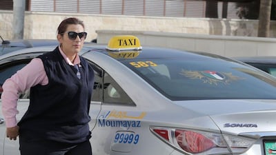 Nisrin Akoubeh, a mother of three, is a taxi driver in Amman, Jordan. It is a rare occupation for a woman in the conservative Muslim society. Khalil Mazraawi / Agence France-Presse