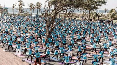 Hundreds of people take part in a yoga session at North Beach in Durban, South Africa. Rajesh Jantilal / AFP