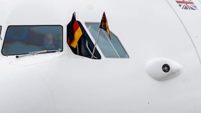 The German flag and the Royal Standard of the UK fly from the plane carrying King Charles. AFP
