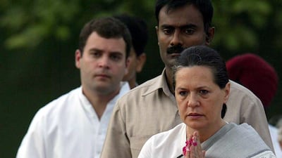Sonia Gandhi and her son Rahul, left, pray at the memorial to her late husband and former prime minister Rajiv Gandhi in New Delhi on May 21, 2004, the 13th anniversary of his assassination. Harish Tyagi / EPA