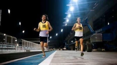 Sean Stewart and Connie Bouverot of the Abu Dhabi Striders running at Yas Circuit. Lee Hoagland / The National