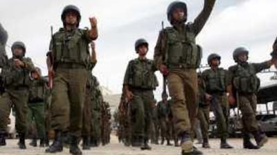 Palestinian police troops parade in Hebron during a rally marking the declaration of independence