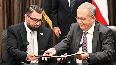 Syria's Justice Minister Mazhar Al Wais, left, and Lebanese Deputy Prime Minister Tarek Metri exchange signed prisoner swap agreements at the Grand Serail in Beirut. AFP