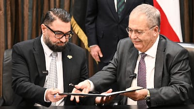 Syria's Justice Minister Mazhar Al Wais and Lebanese Deputy Prime Minister Tarek Metri, exchange signed prisoner swap agreements at the Grand Serail in Beirut. AFP