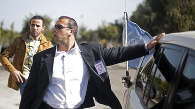 A private guard from Gaza’s first private security company stands guard near the car carrying Palestinian singer and Arab Idol winner Mohammed Assaf.