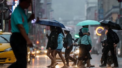 People cross the street under the rain as typhoon Mitag is expected to hit northern Taiwan, in Keelung, Taiwan. According to report, Typhoon Mitag will disrupt air, land and water traffic. Mitag is located at sea about 290 kilometers off the south-southeast of Yilan County, moving at 27 kilometers per hour at a northwesterly direction, with maximum sustained winds of 126 kilometers per hour, with gusts of up to 162 kilometers per hour, and with a radius of 180 kilometers, according to Taiwan Central Weather Bureau. EPA