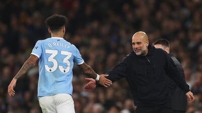 City manager Pep Guardiola shakes the hand of Nico O'Reilly after he scored the third goal. Getty Images