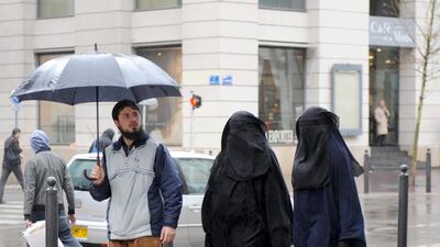 Two veiled women walk down a street in Marseille, France. AFP