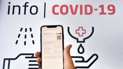 A man checks his EU digital covid certificate on his mobile phone at El Prat Airport in Barcelona, Spain.