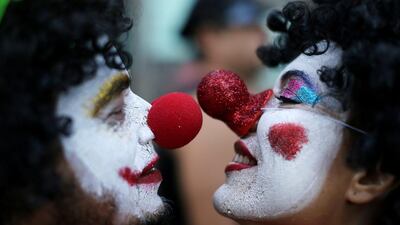 A couple of clowns get nosy on February 23, 2014, at the Boitata block party, a pre-Carnival celebration in Rio de Janeiro, Brazil. Carnival officially begins February 28. Leo Correa / AP photo