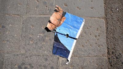A torn picture of Ali Abdullah Saleh sits on the ground in Sanaa's Old City. (Photo: Lindsay Mackenzie for The National)