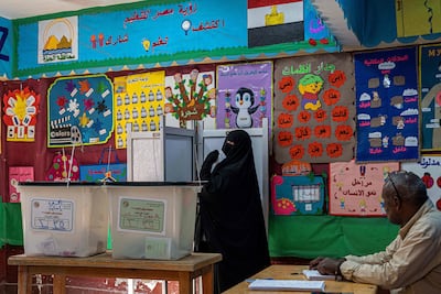 A voter casts her ballot at a polling station in Giza. AFP