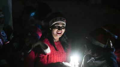 Abu Dhabi, United Arab Emirates - People enjoy during the singing of Christmas carols by candlelight in the desert. Khushnum Bhandari for The National