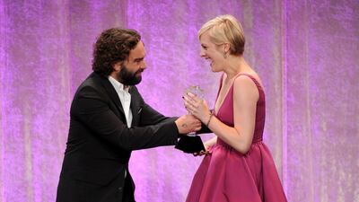 Elisabeth Moss, right, accepts award for best actress in a movie or mini-series for Top of the Lake from presenter Johnny Galecki. Frank Micelotta / Invision / AP