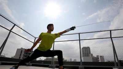 Japan's Olympic fencing medallist Ryo Miyake trains at the rooftop of his apartment under a nationwide state of emergency as the spread of the coronavirus disease continues in Tokyo. Reuters