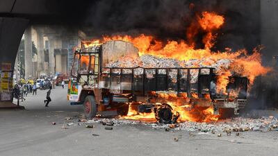 A lorry burns after it was set alight by activists as the water dispute erupted following the Supreme Court's order to release water to Tamil Nadu in Bangalore. Manjunath Kiran / AFP
