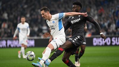 Marseille forward Arkadiusz Milik tangles with Monaco's Benoit Badiashile. AFP