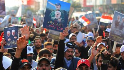 Iraqi supporters of the Hashed al-Shaabi paramilitary carry portraits of Iraqi commander Abu Mahdi al-Muhandis and Iranian Revolutionary Guards commander Qasem Soleimani during a demonstration in Baghdad's western Shoala neighbourhood. AFP