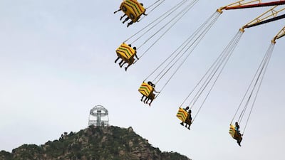 The platform on Shilin Gorge is seen over a ride at an amusement park in Beijing. Kim Kyung-Hoon / Reuters