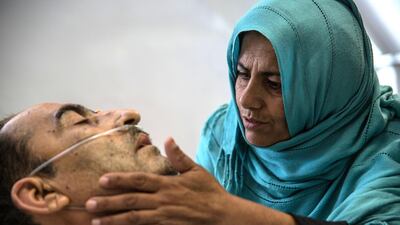 Shir Ali, 49, lies in hospital with his wife Qudsia, 48, by his side. The shock and pain of Monday's attack is raw. Stefanie Glinski for The National