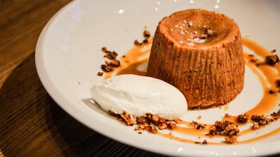 A dulce de leche fondant with pecans and vanilla cream, from the dessert menu at Sucre.