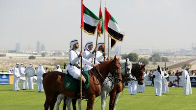 Men on horseback carry the UAE flag on the 2019 opening meeting at Jebel Ali racecourse. Researchers in Dubai have developed a vaccine against African Horse Sickness that is fatal in 80 per cent of animals. Chris Whiteoak / The National