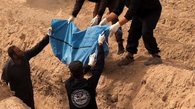 The rescue team removes a dozen bodies to be buried in a cemetery on the outskirts of the Syrian city. Charles Thiefaine for The National