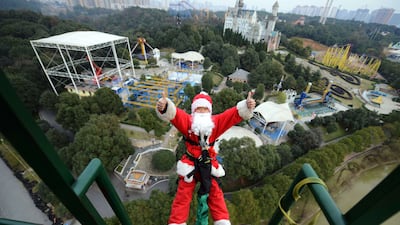 This picture, taken on December 18, 2014, shows a man dressed up as Santa Claus bungee-jumping at a theme park in Changsha, central China's Hunan province. The park organised a series of Santa Claus-themed events ahead of Christmas. AFP Photo