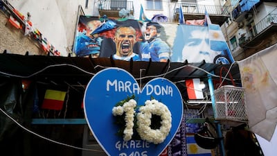 A heart-shaped placard reading "Maradona, thanks God" is pictured the day after the death of Diego Maradona, in Naples. Reuters