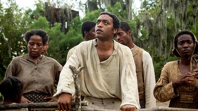 This image released by Fox Searchlight shows Chiwetel Ejiofor, center, in a scene from 12 Years A Slave. (AP Photo/Fox Searchlight, Jaap Buitendijk)